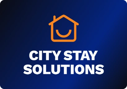 City Stay Solutions logo: An orange house outline with a smile inside it, over a heavy rounded wordmark.