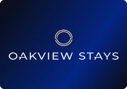 Oakview Stays logo: A ring emblem in copper tones over a thin, widely spaced wordmark.