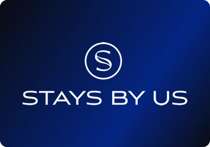 Stays By Us logo: An S in a circle over a wide sans-serif wordmark.